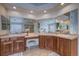 Bathroom with and sinks, vanity, and large mirrors at 1035 Cryolite Pl, Castle Rock, CO 80108