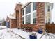 Brick home with a covered entryway and landscaping at 1035 Cryolite Pl, Castle Rock, CO 80108