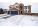 Two-story brick home with a large yard and attached two-car garage at 1035 Cryolite Pl, Castle Rock, CO 80108