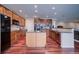 Spacious kitchen with island, wood cabinets, and granite countertops at 1035 Cryolite Pl, Castle Rock, CO 80108