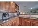 Kitchen with granite countertop, wooden cabinets, and coffee station at 1035 Cryolite Pl, Castle Rock, CO 80108