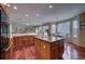 Kitchen with island, granite counters, and hardwood floors at 1035 Cryolite Pl, Castle Rock, CO 80108