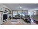 Relaxing living room with a fireplace, large windows, and comfortable seating at 1035 Cryolite Pl, Castle Rock, CO 80108