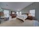 Bright main bedroom with a king-size bed, desk, and ample closet space at 1035 Cryolite Pl, Castle Rock, CO 80108