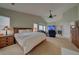 Main bedroom with sitting area, fireplace, and large TV at 1035 Cryolite Pl, Castle Rock, CO 80108