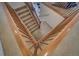 Wooden staircase with carpet runner and wooden railings at 1035 Cryolite Pl, Castle Rock, CO 80108