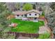 Aerial view of the fenced backyard featuring a well-maintained lawn, patio, mature trees, and a storage shed at 1821 E Kettle Ave, Centennial, CO 80122