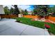 An expansive backyard features a lush lawn, stained wood fence, storage shed, and a concrete patio for outdoor enjoyment at 1821 E Kettle Ave, Centennial, CO 80122