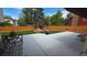 A backyard boasts a well-maintained lawn, tasteful landscaping, a concrete patio and a wooden fence for privacy at 1821 E Kettle Ave, Centennial, CO 80122