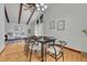 Charming dining room area features exposed wood beams, hardwood flooring, and natural lighting at 1821 E Kettle Ave, Centennial, CO 80122