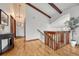 Bright entryway features hardwood floors, wood beams, and a staircase at 1821 E Kettle Ave, Centennial, CO 80122