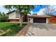 Charming home featuring a well-manicured lawn, attached two-car garage, and a mix of brick and siding at 1821 E Kettle Ave, Centennial, CO 80122