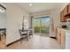 Bright kitchen nook featuring a sliding glass door to a deck and wood cabinetry at 1821 E Kettle Ave, Centennial, CO 80122