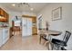 Eat-in kitchen featuring tile flooring, natural-toned wood cabinets, and an adjacent dining area at 1821 E Kettle Ave, Centennial, CO 80122