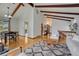 Open-concept living and dining area featuring hardwood floors, exposed beams, and abundant natural light at 1821 E Kettle Ave, Centennial, CO 80122