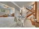 Spacious basement living room with a charming fireplace and staircase to the upper level at 1821 E Kettle Ave, Centennial, CO 80122