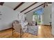 Inviting living room with hardwood floors, high ceilings, exposed beams, and ample natural light at 1821 E Kettle Ave, Centennial, CO 80122