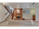 Cozy living room features a brick fireplace and access to the upper floor at 1821 E Kettle Ave, Centennial, CO 80122