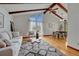 Stylish living and dining area featuring hardwood floors, exposed beams, and abundant natural light at 1821 E Kettle Ave, Centennial, CO 80122