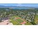 Scenic aerial view of a neighborhood with mountain views near a school with athletic fields and track at 8705 W 86Th Dr, Arvada, CO 80005