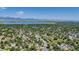 Expansive aerial view of a neighborhood near a serene lake and majestic mountains in the background at 8705 W 86Th Dr, Arvada, CO 80005