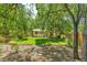Spacious backyard with lush lawn, mature trees, and a charming wooden deck at 8705 W 86Th Dr, Arvada, CO 80005