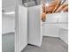 Basement area with unfinished utility area, washer, dryer, and doorway into main finished room at 8705 W 86Th Dr, Arvada, CO 80005