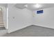 Finished basement area with neutral walls, carpet, window, and doorway leading to stairs at 8705 W 86Th Dr, Arvada, CO 80005