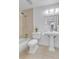 Cozy bathroom featuring a shower-tub combination, pedestal sink, and tile flooring at 8705 W 86Th Dr, Arvada, CO 80005