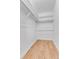 Walk-in closet space with modern shelving and hardwood floors at 8705 W 86Th Dr, Arvada, CO 80005