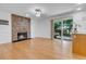 Dining area with a stone fireplace, sliding glass doors, and hardwood flooring at 8705 W 86Th Dr, Arvada, CO 80005