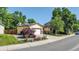 Charming single-Gathering home with a well-manicured front yard featuring colorful flowers and mature trees at 8705 W 86Th Dr, Arvada, CO 80005