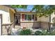 Charming home entrance with solar panels, brick accents, and an open doorway, inviting guests inside at 8705 W 86Th Dr, Arvada, CO 80005