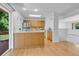 Open-concept kitchen and dining area with stainless steel appliances and hardwood flooring at 8705 W 86Th Dr, Arvada, CO 80005