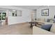 Open-concept living area with hardwood flooring, neutral decor, and plenty of natural light at 8705 W 86Th Dr, Arvada, CO 80005