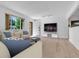 Bright living room featuring modern decor, hardwood floors, and large windows at 8705 W 86Th Dr, Arvada, CO 80005