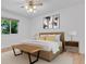 Bright main bedroom with ceiling fan, bench, neutral decor, and natural light at 8705 W 86Th Dr, Arvada, CO 80005