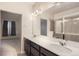 An expansive bathroom with dual sinks, modern fixtures, and a glass-enclosed shower at 9269 Garnett St # C, Arvada, CO 80007