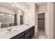 An expansive bathroom with dual sinks, modern fixtures, and a glass-enclosed shower at 9269 Garnett St # C, Arvada, CO 80007