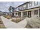 Attractive townhome showcasing neat landscaping and a cozy front seating area at 9269 Garnett St # C, Arvada, CO 80007