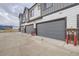 Row of modern townhomes featuring gray garage doors and white and gray siding at 9269 Garnett St # C, Arvada, CO 80007