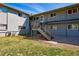 Exterior view of a multi-unit building with stairs and green lawn at 2595 S Sheridan Blvd # 20, Denver, CO 80227