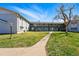 Apartment complex with well-maintained lawn, sidewalk and mature trees at 2595 S Sheridan Blvd # 20, Denver, CO 80227