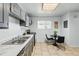 The eat-in kitchen features a tiled floor, stainless steel appliances, and neutral-colored cabinets at 2595 S Sheridan Blvd # 20, Denver, CO 80227