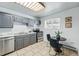 Bright eat-in kitchen with neutral colored cabinets, tiled floor, and stainless steel appliances at 2595 S Sheridan Blvd # 20, Denver, CO 80227