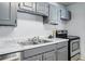 Kitchen showcasing marble countertops, stainless steel sink, and modern appliances at 2595 S Sheridan Blvd # 20, Denver, CO 80227