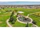 Aerial view showcases a large park with play areas and green spaces, offering a community gathering place at 4312 Windmill Dr, Brighton, CO 80601