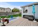 Backyard featuring wooden deck area and outdoor seating, with a fenced in grassy area at 4312 Windmill Dr, Brighton, CO 80601