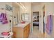 Functional bathroom with a double sink vanity, neutral finishes, and linen storage at 4312 Windmill Dr, Brighton, CO 80601