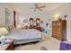 Comfortable bedroom with a ceiling fan, carpet flooring, and well-lit vanity area at 4312 Windmill Dr, Brighton, CO 80601